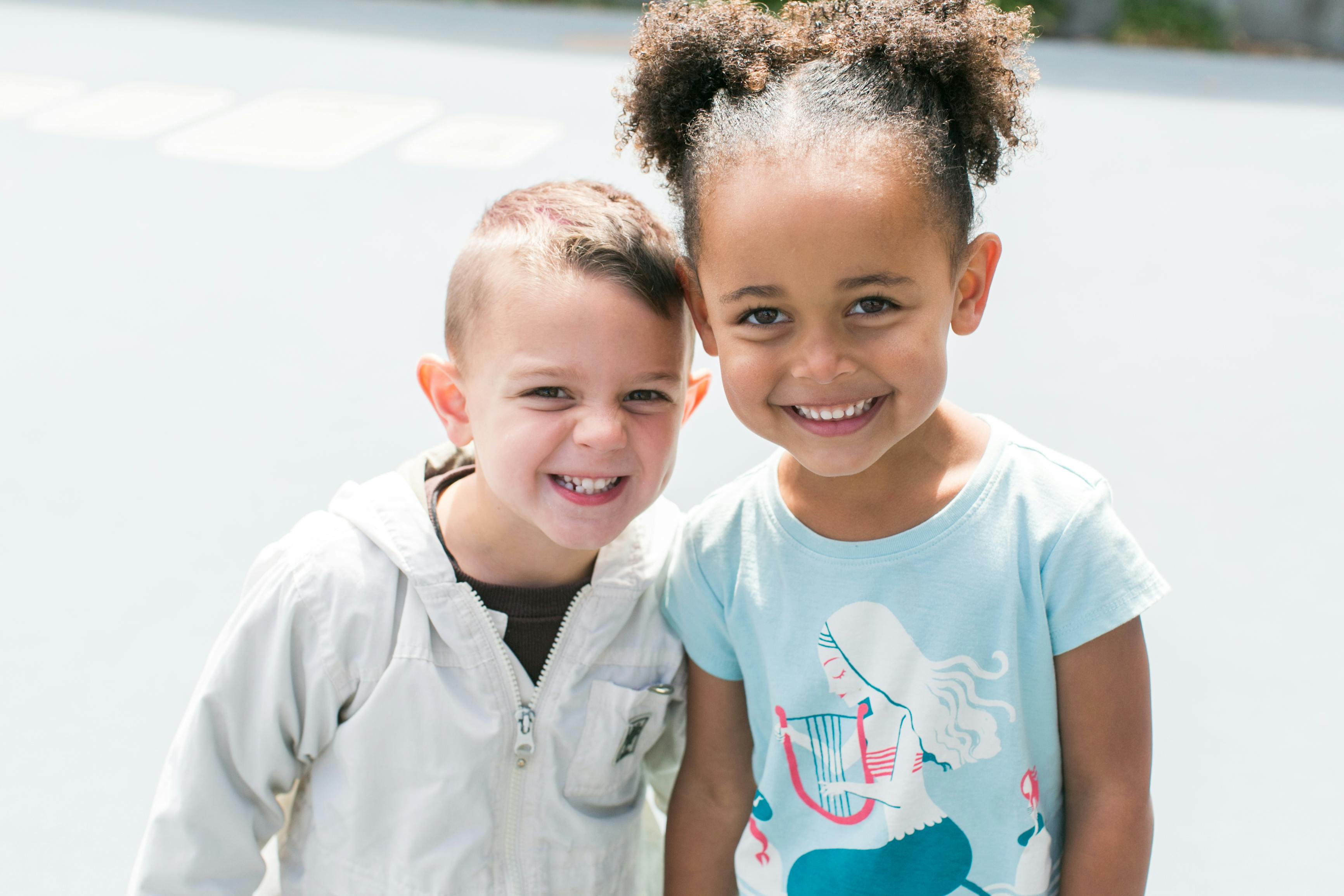 Two children smiling at the camera
