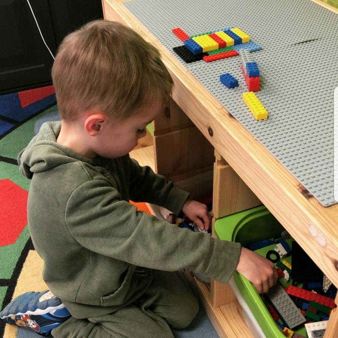 Child playing with building blocks at a table