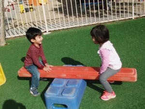 Two children on a seesaw