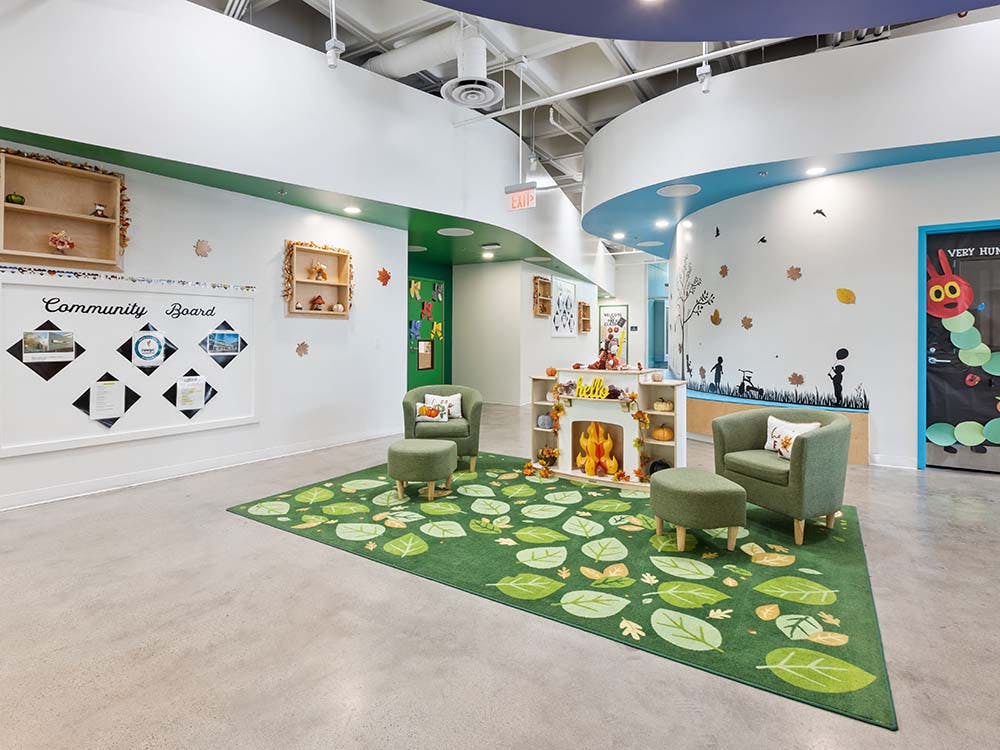 Classroom decorated with autumn leaves and a green rug
