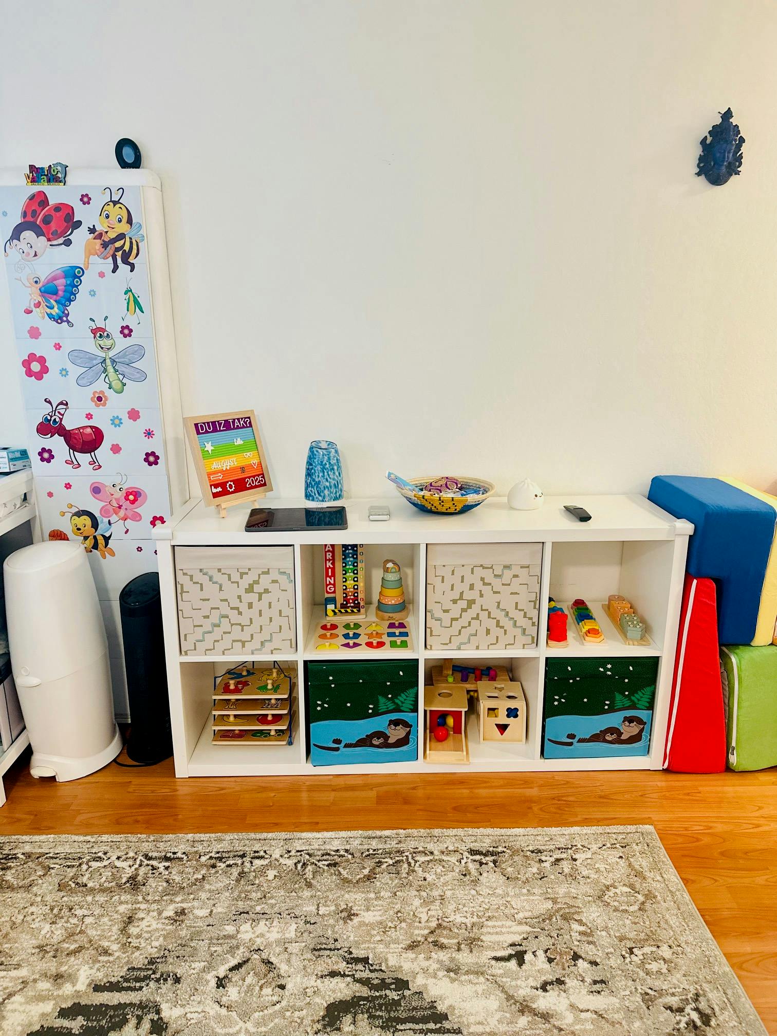 White storage shelf with toys and colorful blocks