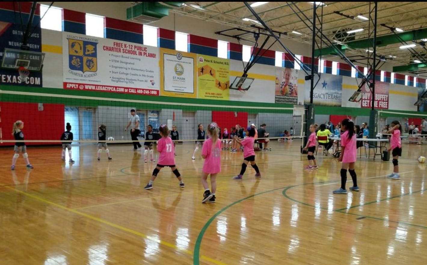 Children playing volleyball on a court