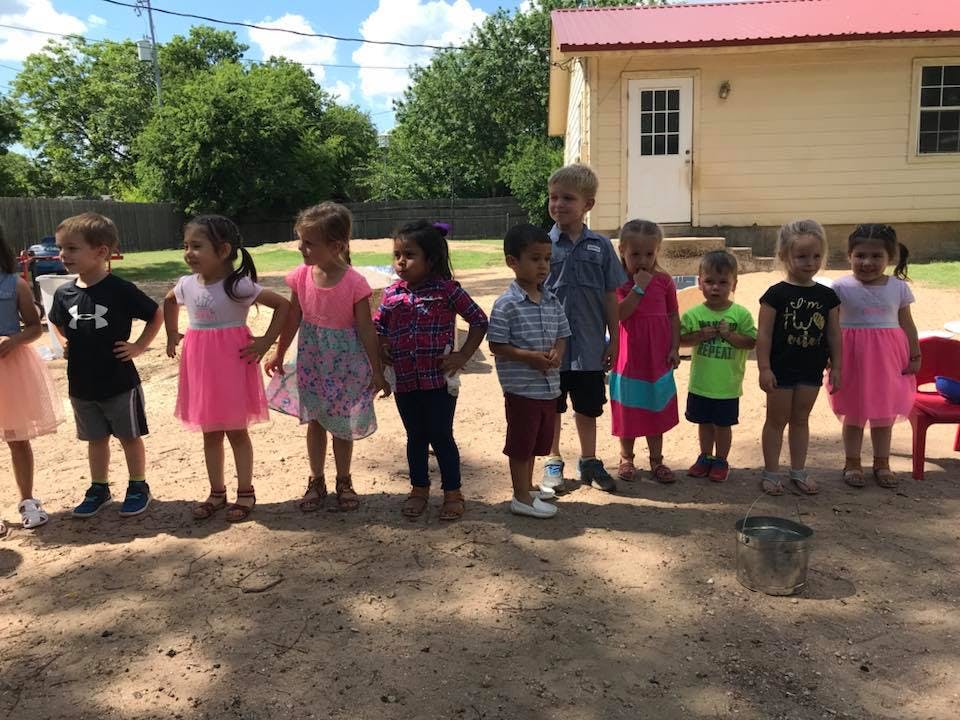 Group of children standing in a line outdoors