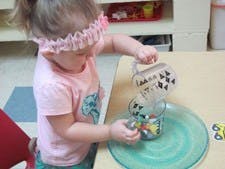 Child pouring from one container to another