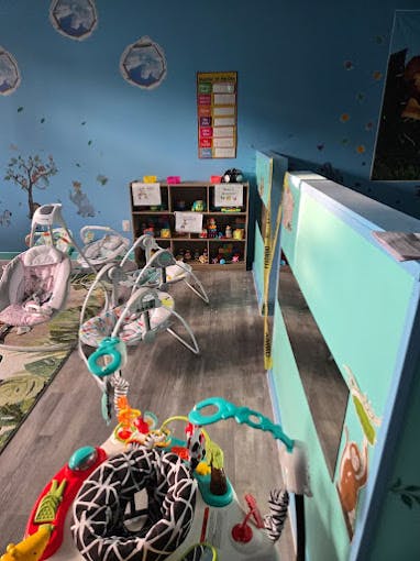 Infant play area with baby bouncers and activity mats