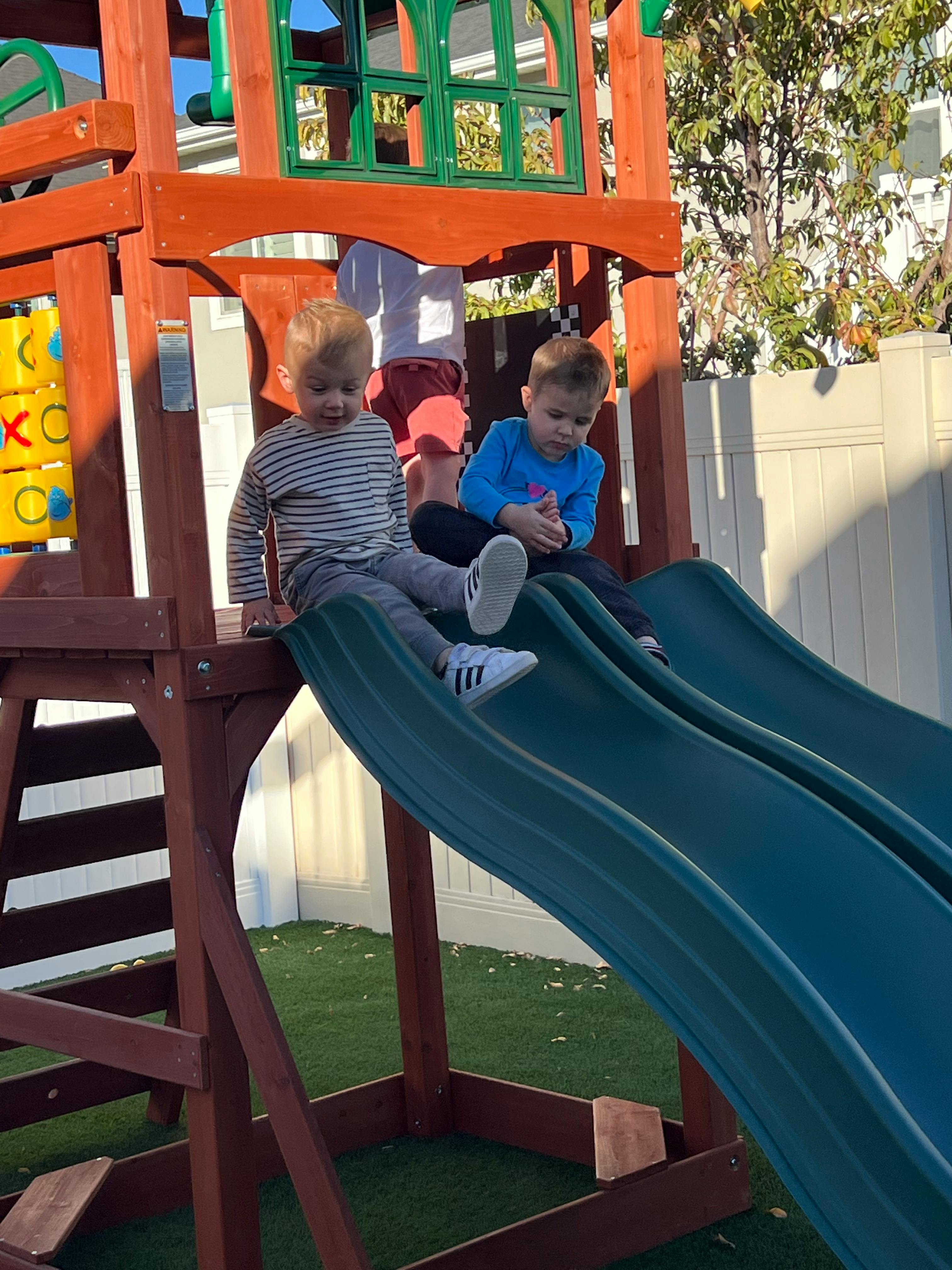 Two children on a playground slide