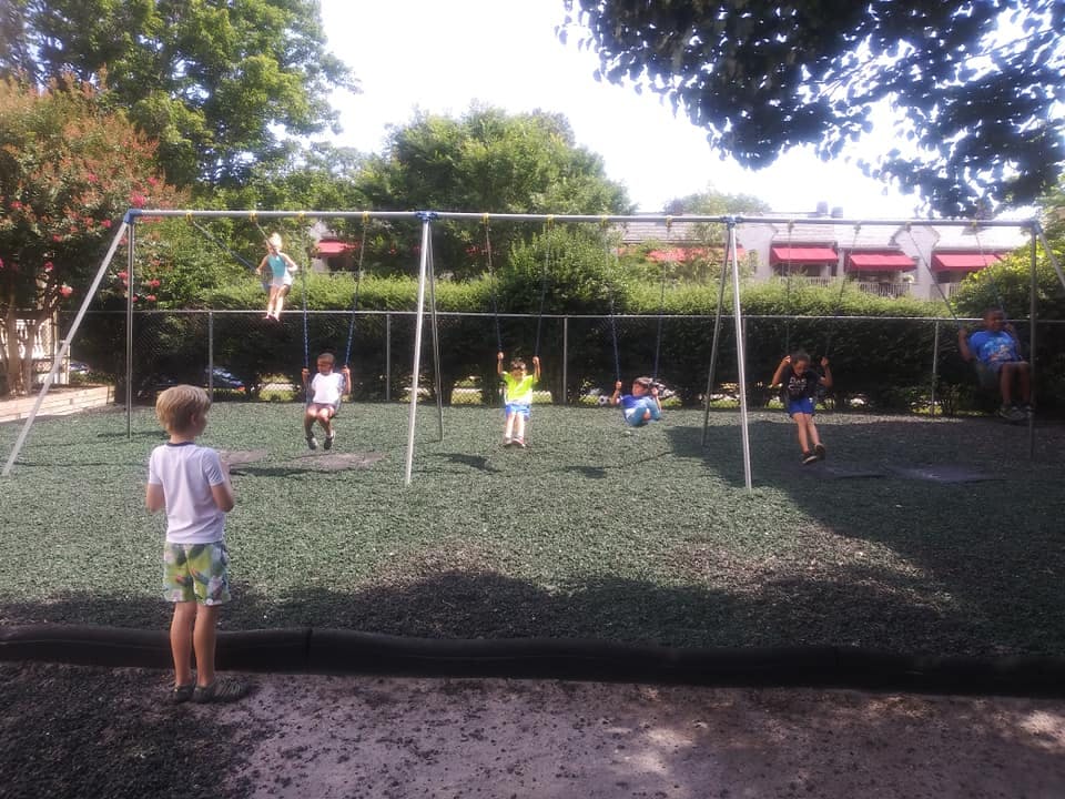 Children playing on swings at a playground
