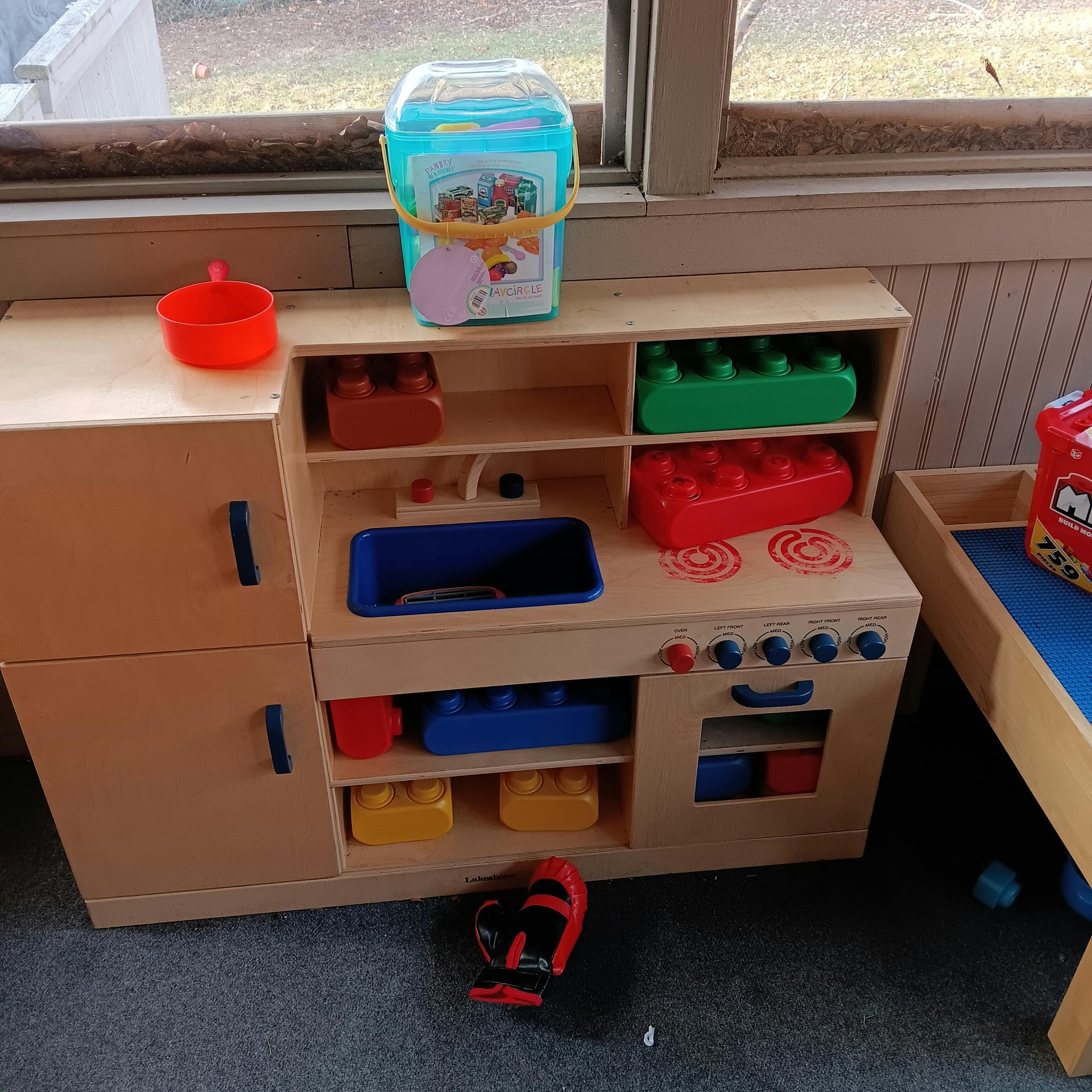 Toy kitchen with blocks and other play items