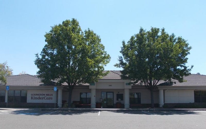 Lexington Hills KinderCare building entrance with two trees in front