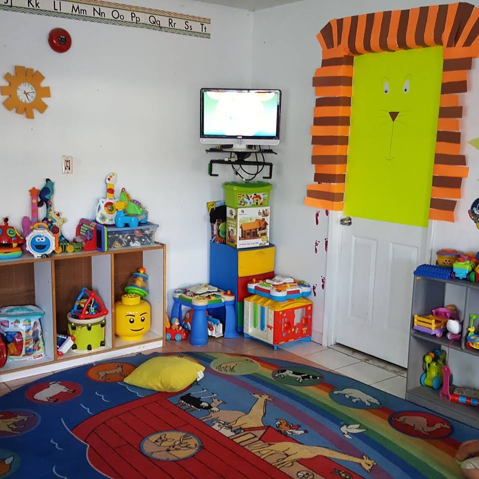 Playroom with toys, shelves, a television, and a colorful rug