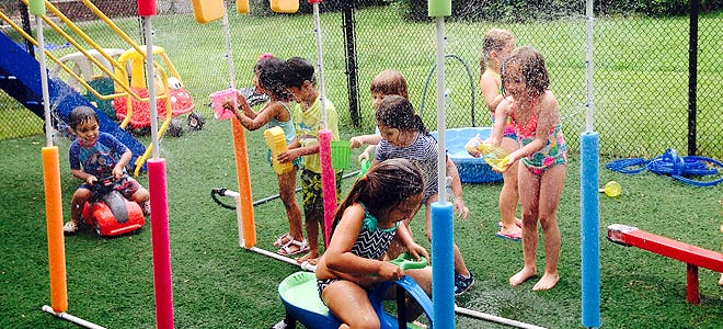Children playing with water toys outdoors