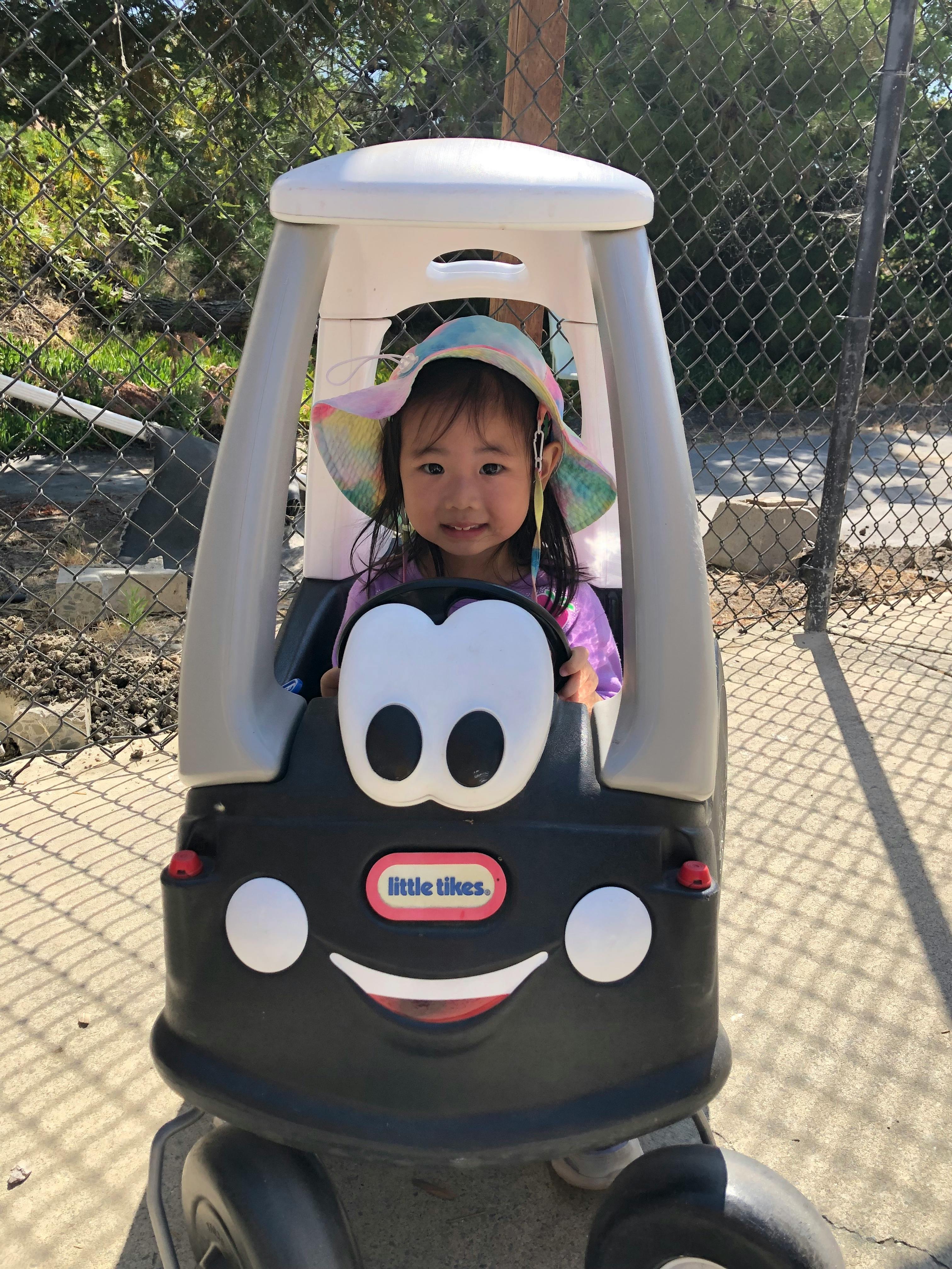 Child in a toy car