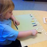 Child working with letter tiles on a table