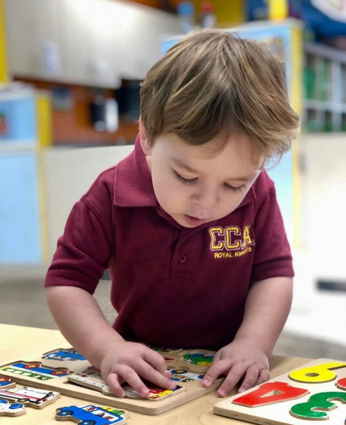 Child playing with a wooden puzzle