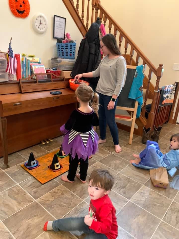 Adult and children in costumes, one child on floor
