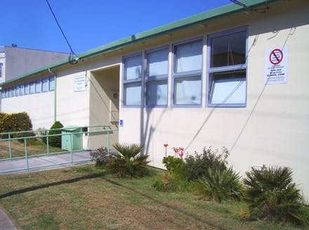 Exterior of a building with windows and a green roof