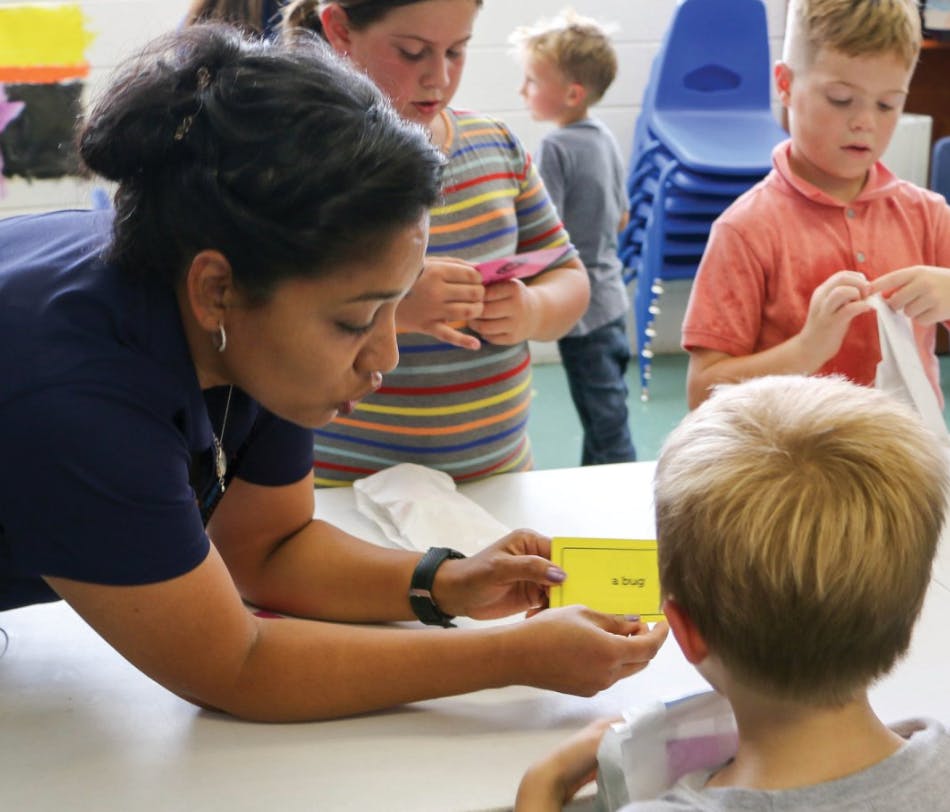 Person showing a yellow card to a child