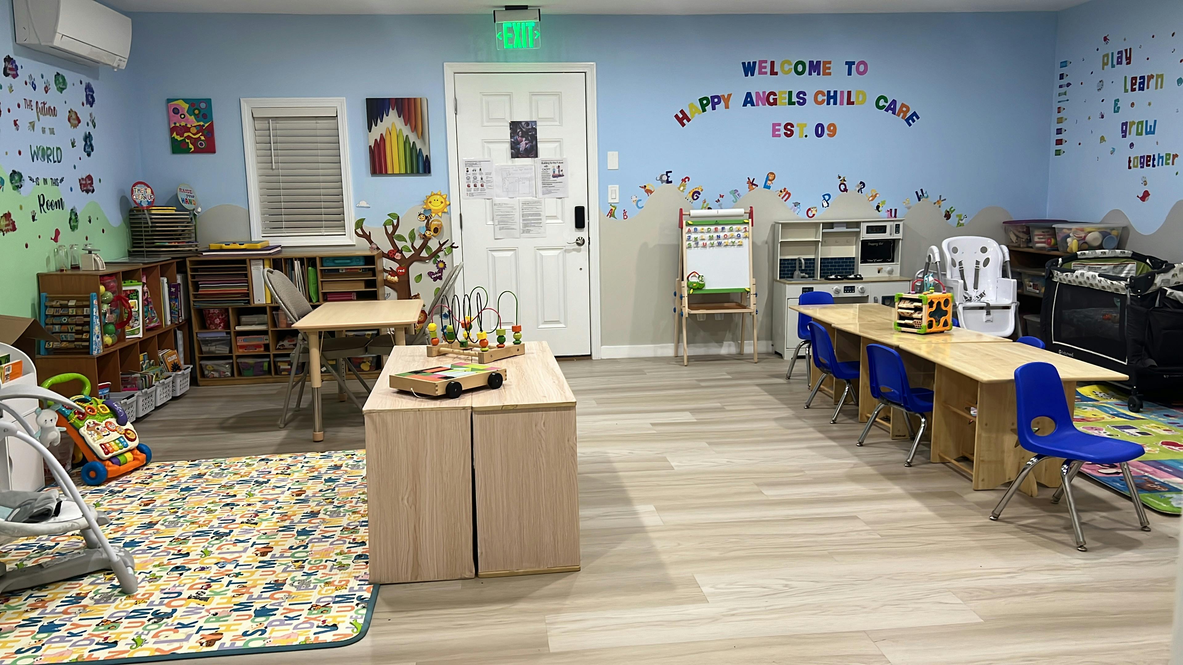 Interior of a brightly decorated childcare room with small tables and chairs