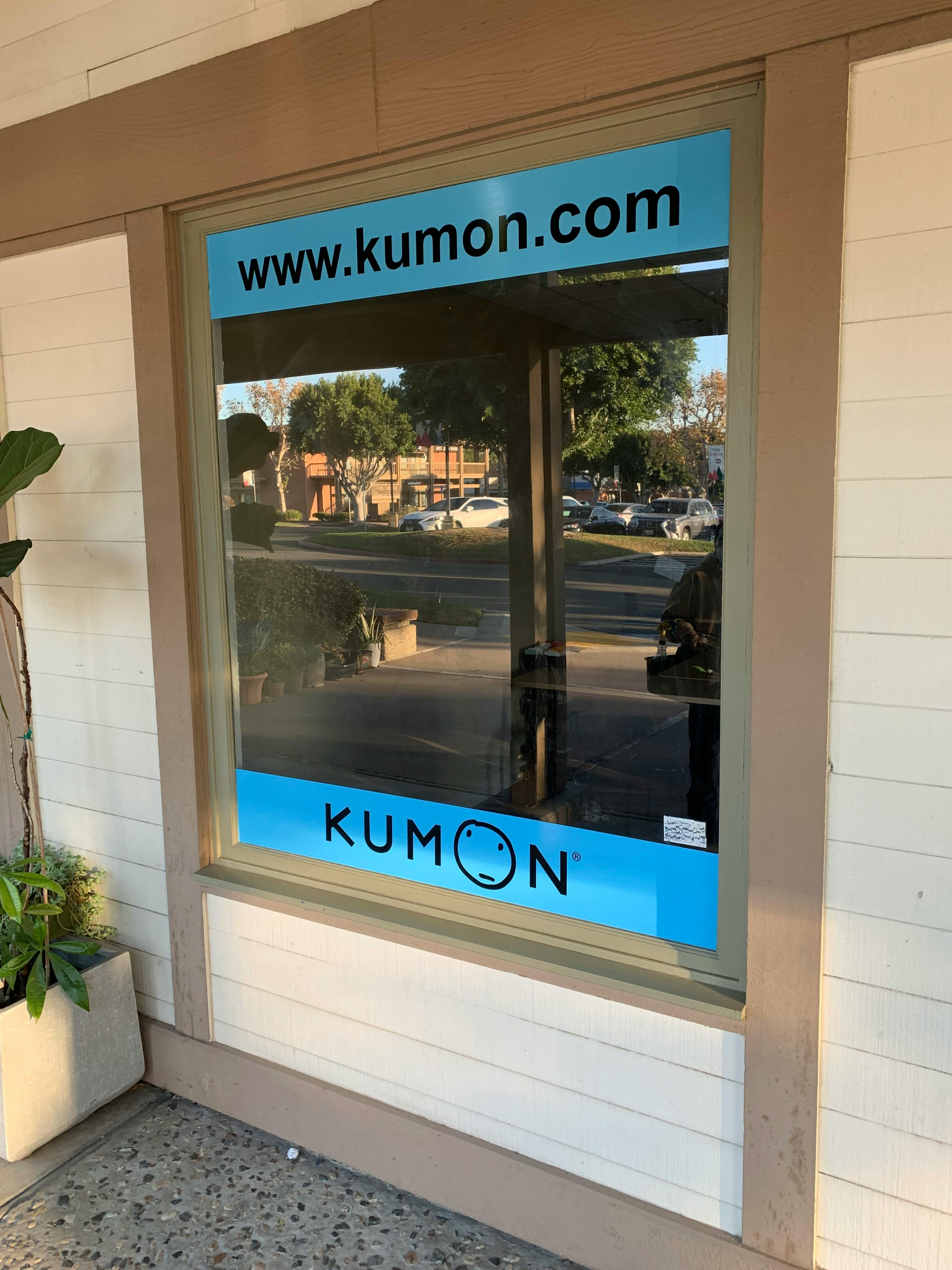Kumon logo and website on a storefront window