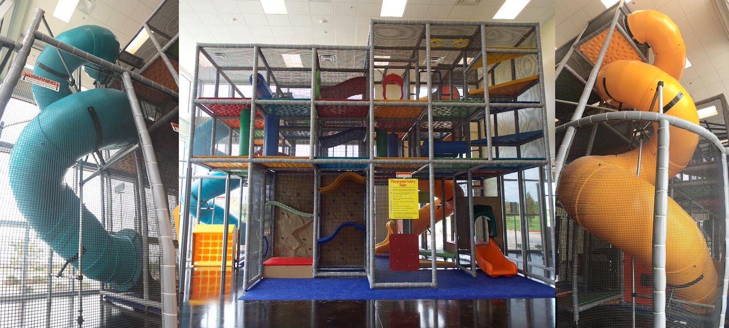 Indoor playground with multiple levels, slides, and climbing structures