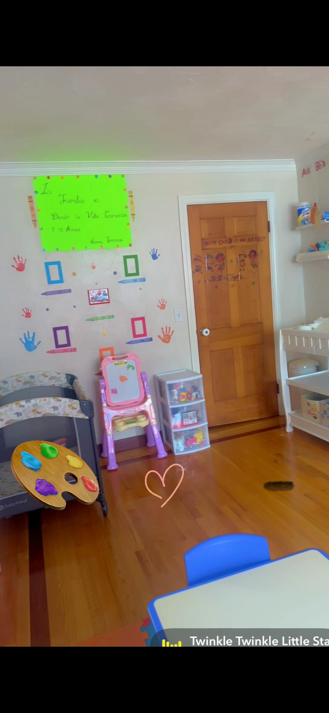Childcare room with wall decorations and play equipment