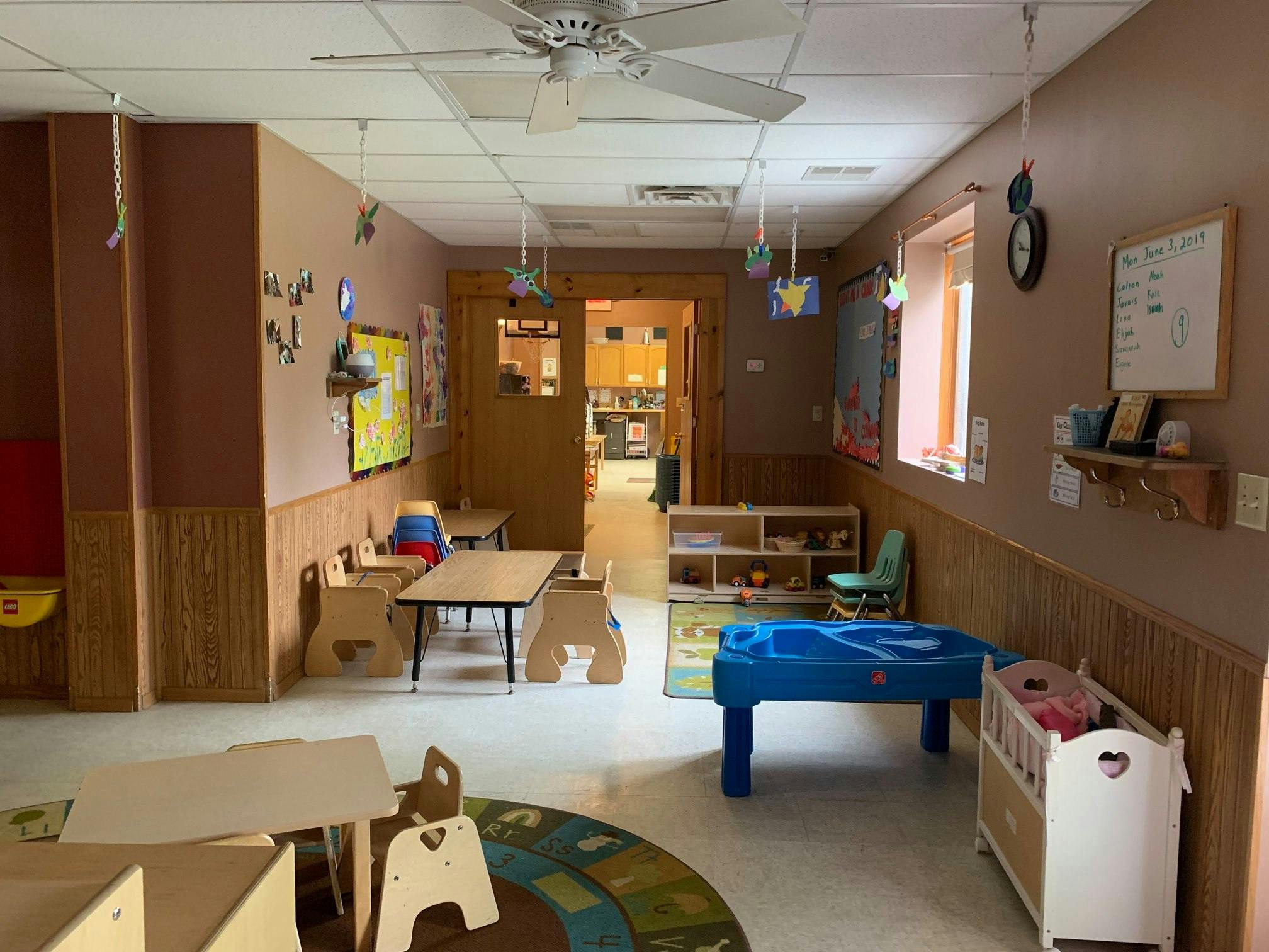 Empty classroom with small tables and chairs