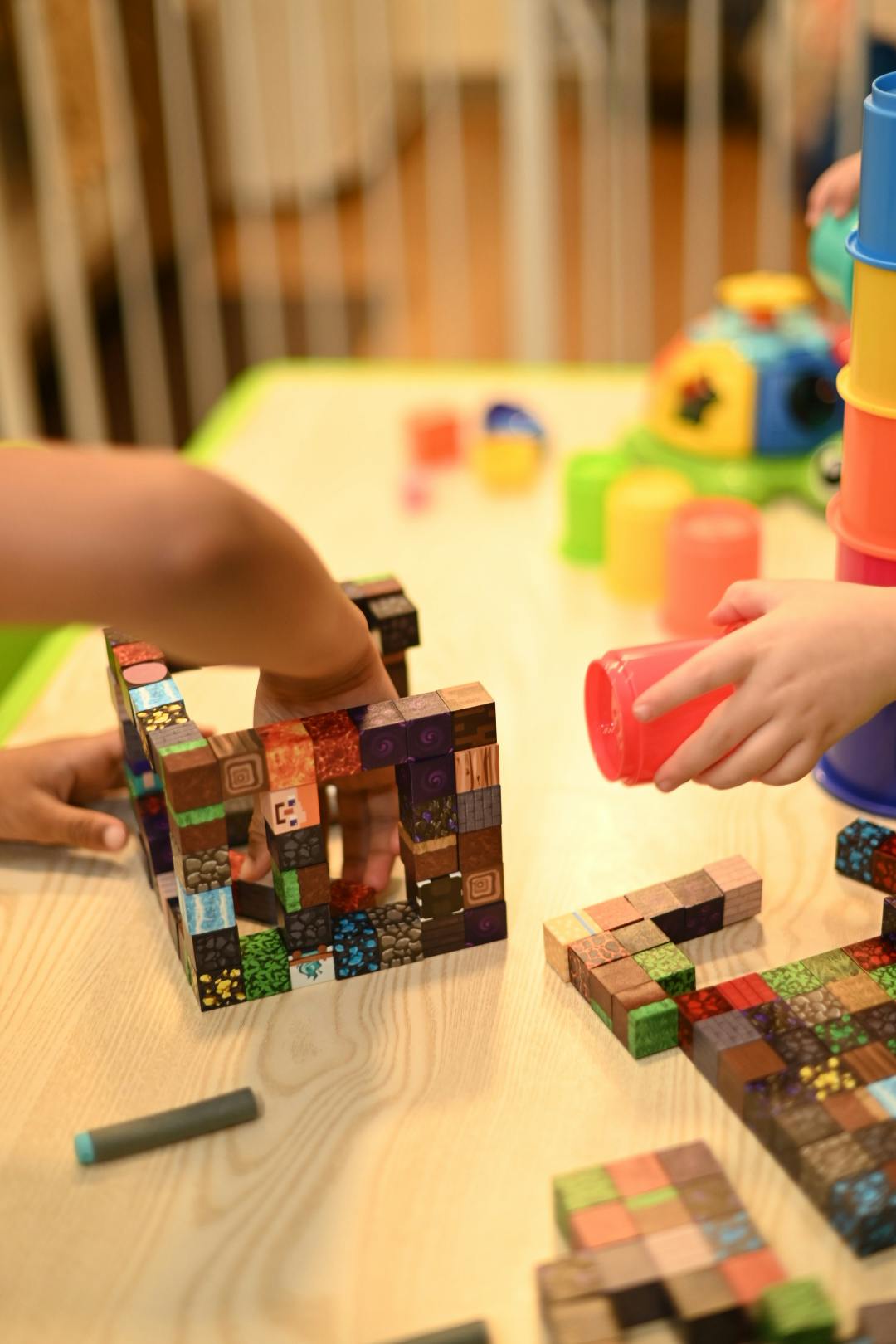 Child's hands playing with colorful building blocks