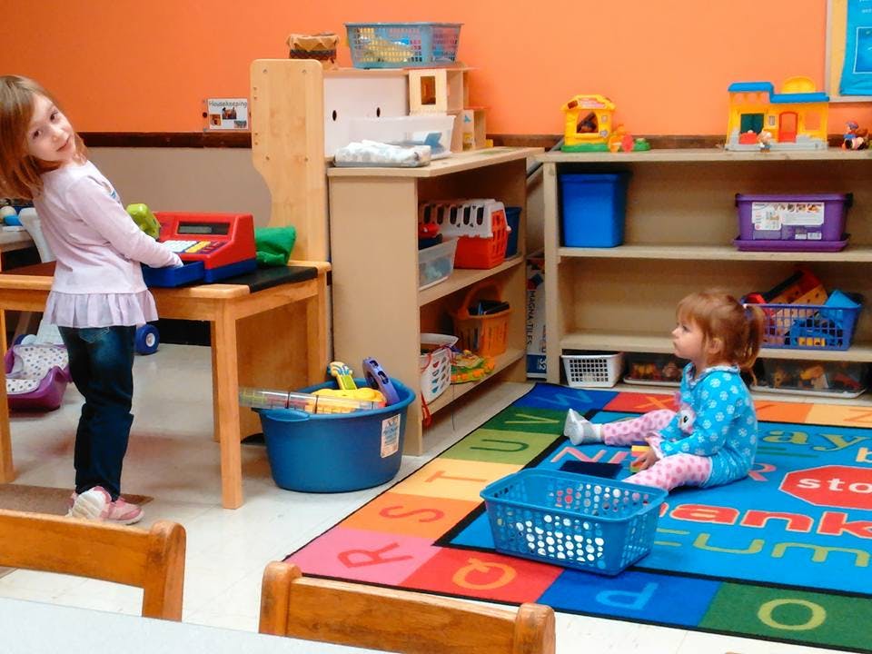 Two children playing in a classroom