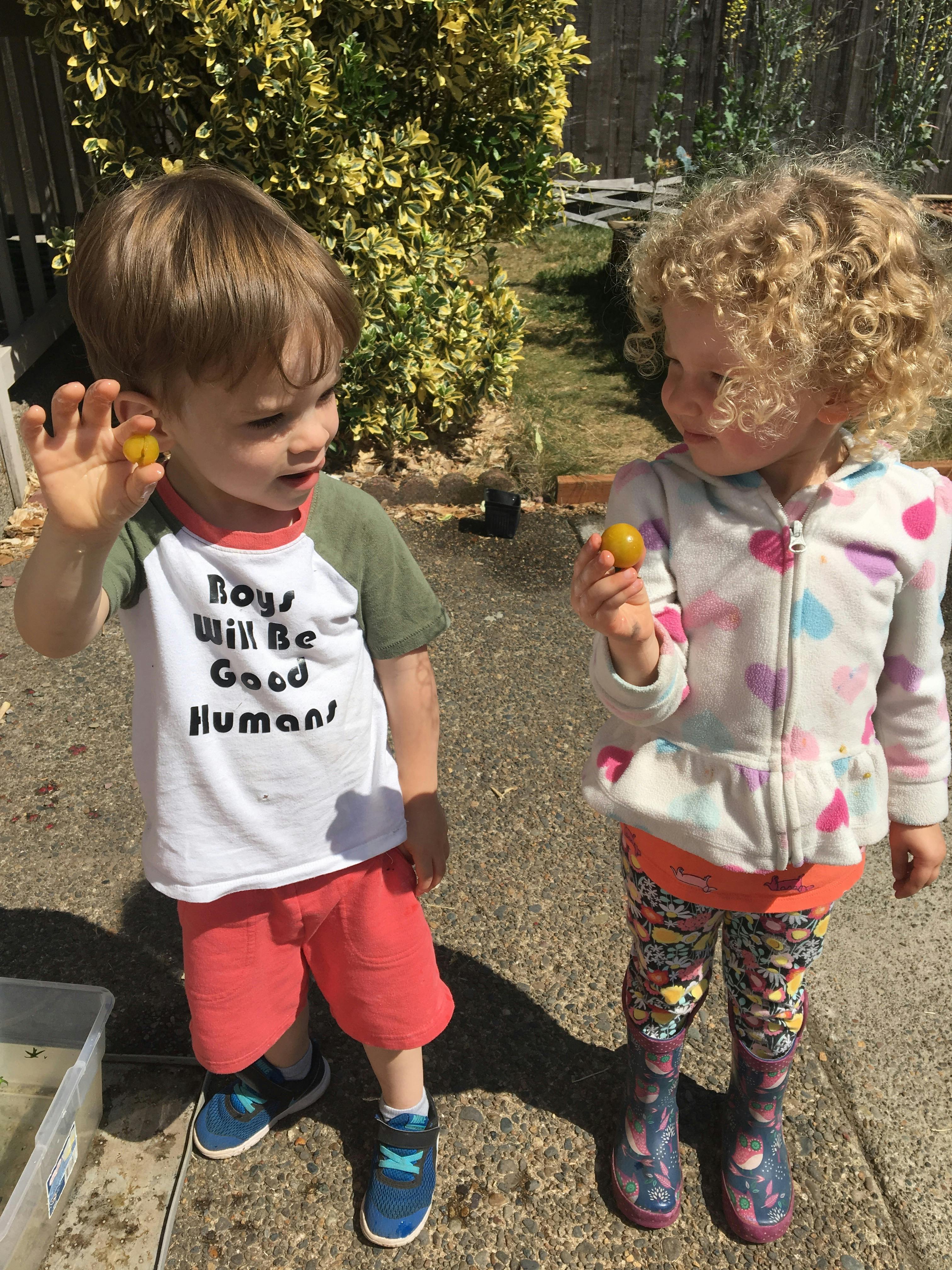 Two children holding small yellow objects