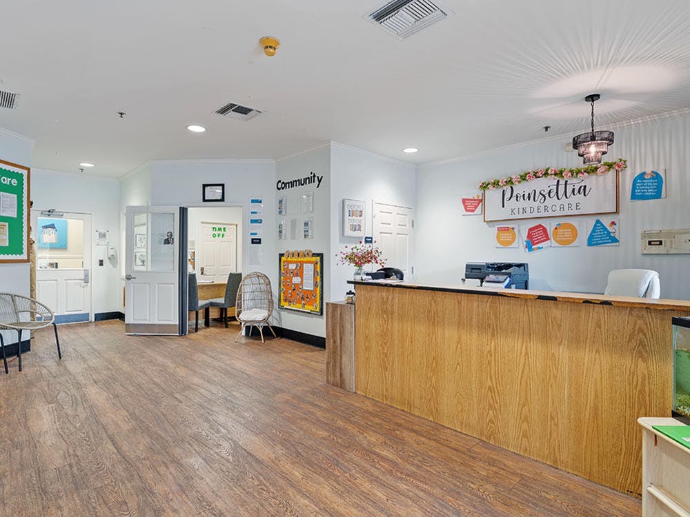 Reception area in a kindercare with a front desk and wooden floors