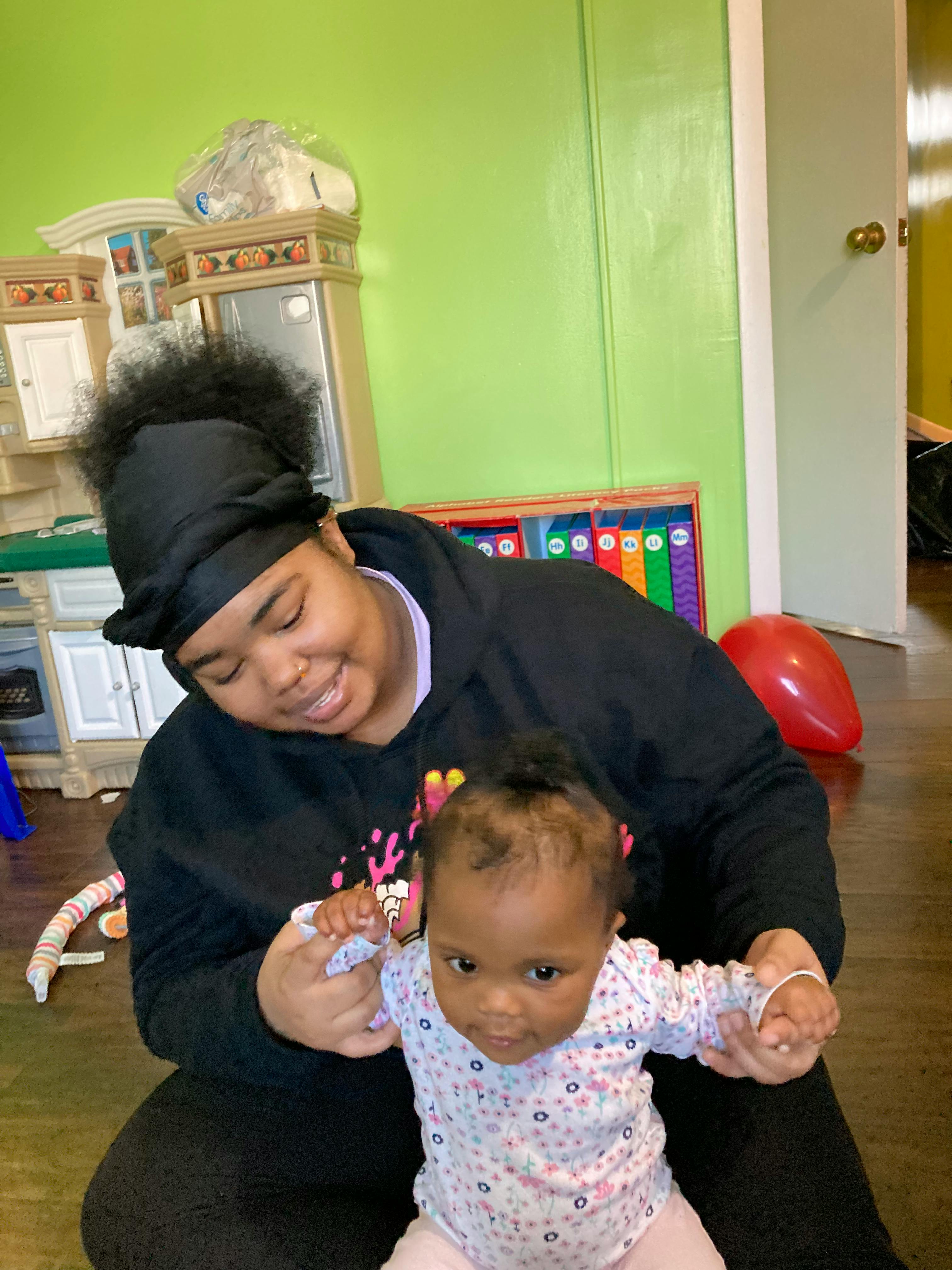 Person holding a child's hands