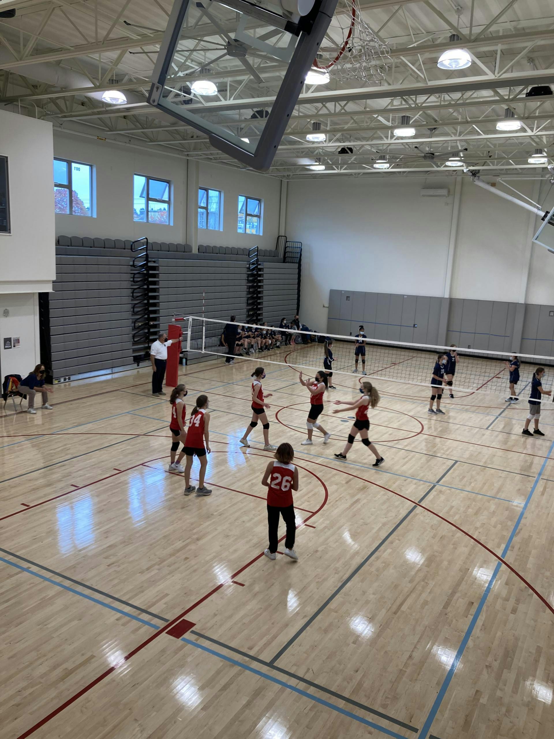 People playing volleyball in a gymnasium