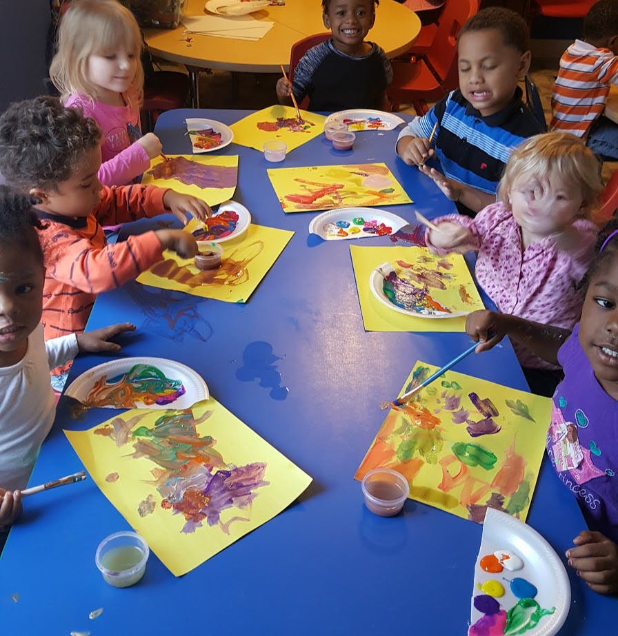 Children painting at a table