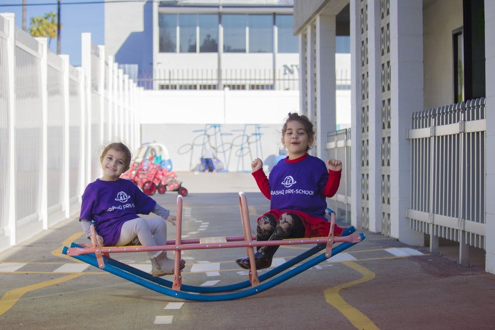 Two children on a seesaw