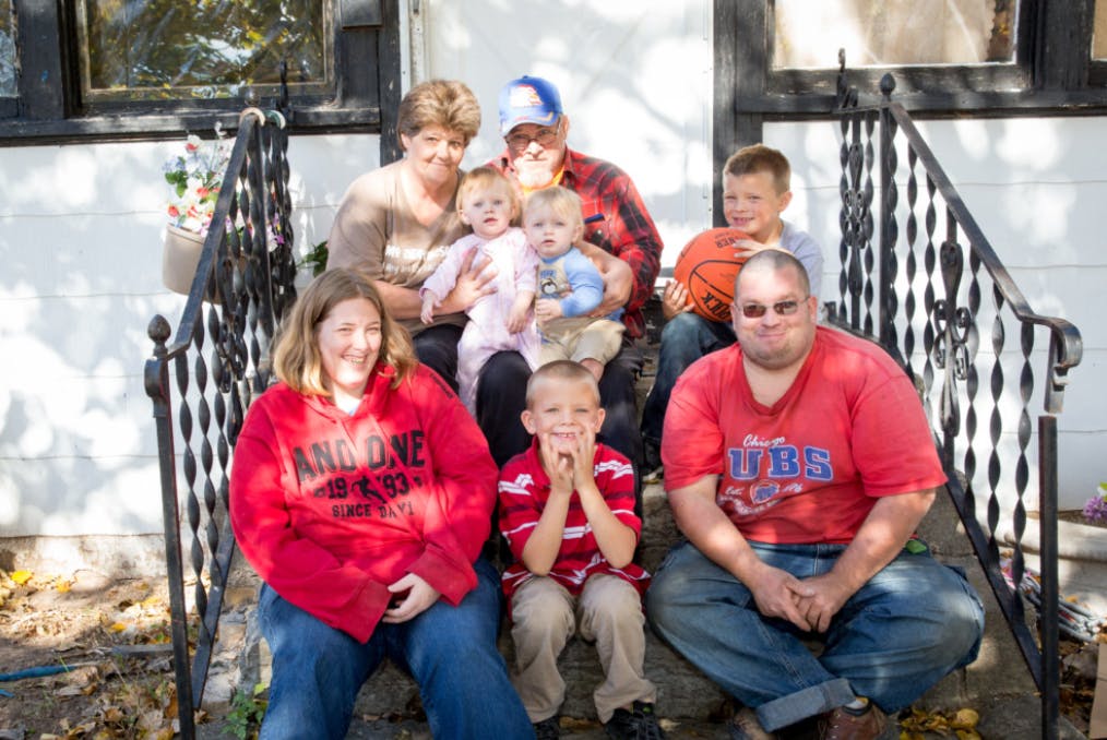 Group of people and children sitting on outdoor steps