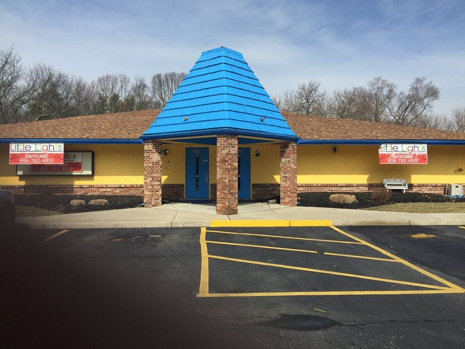 Yellow building with a blue roof over the entrance