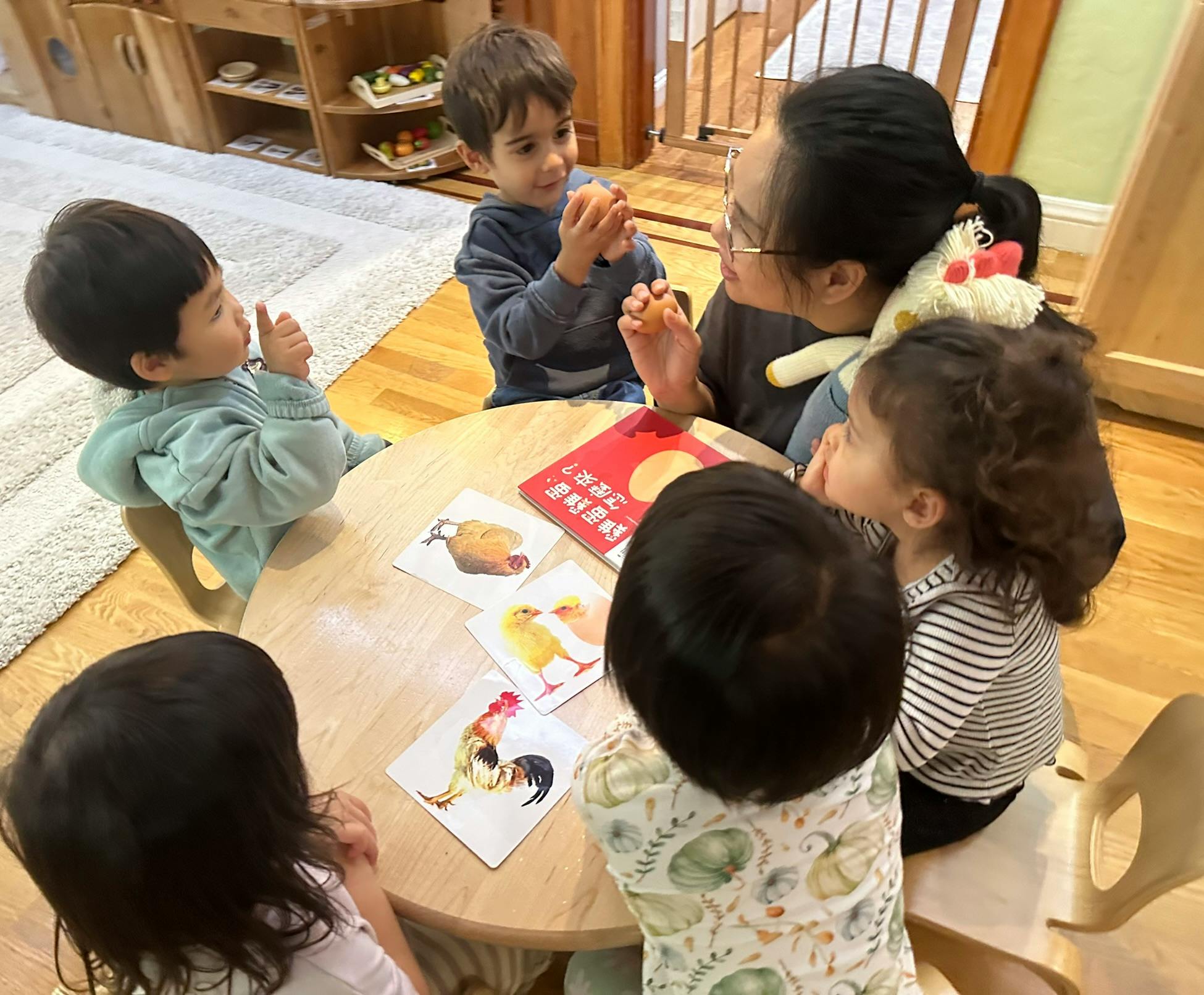 Adult and children sitting around a table with picture cards