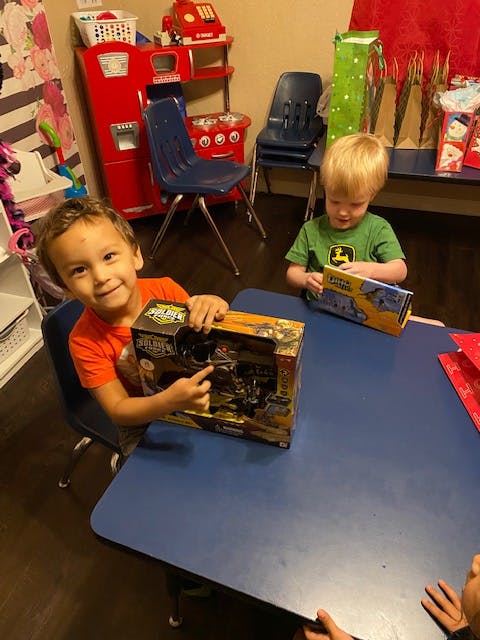 Two children at a table with toys