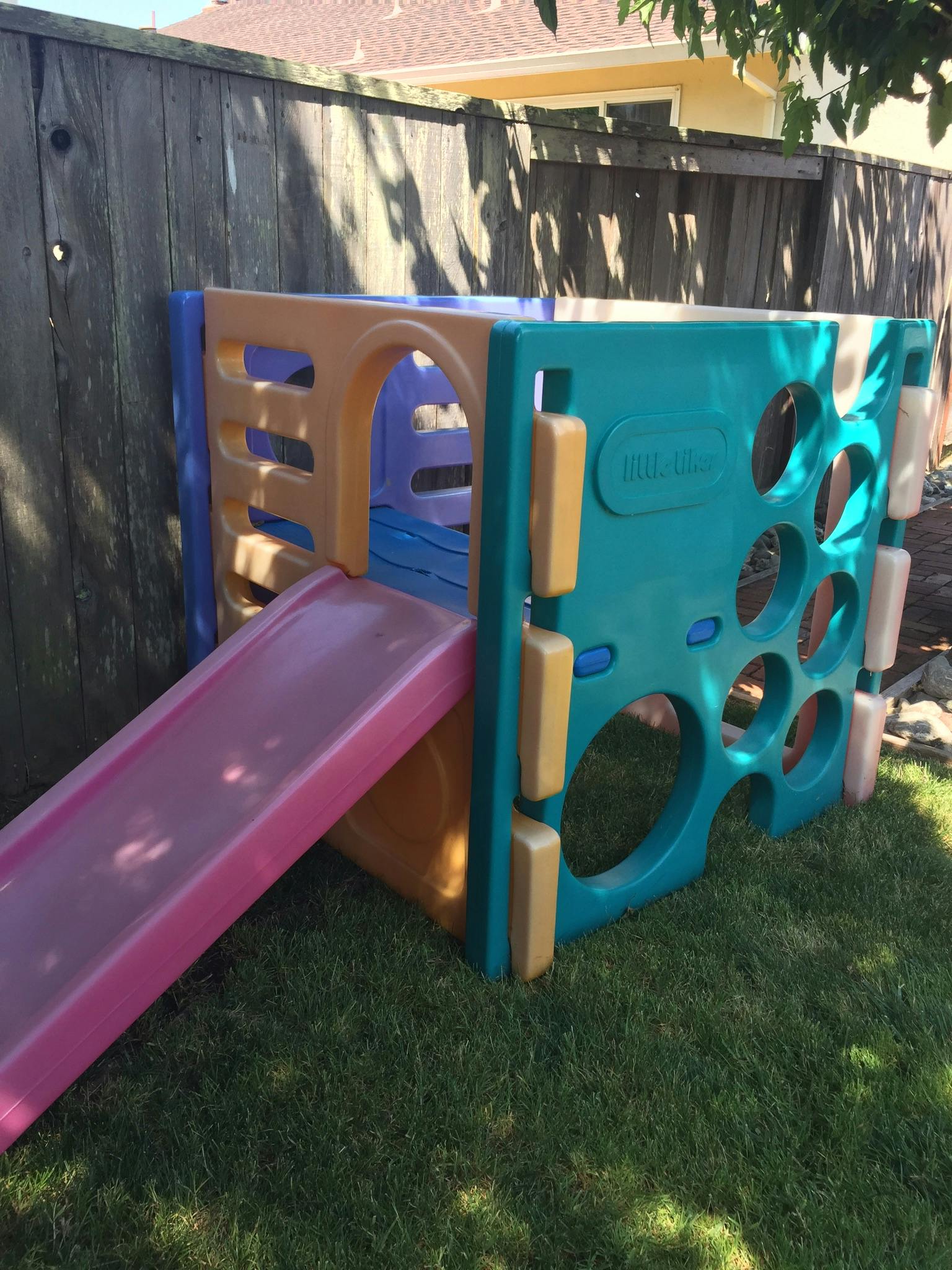Child's plastic play structure with a slide