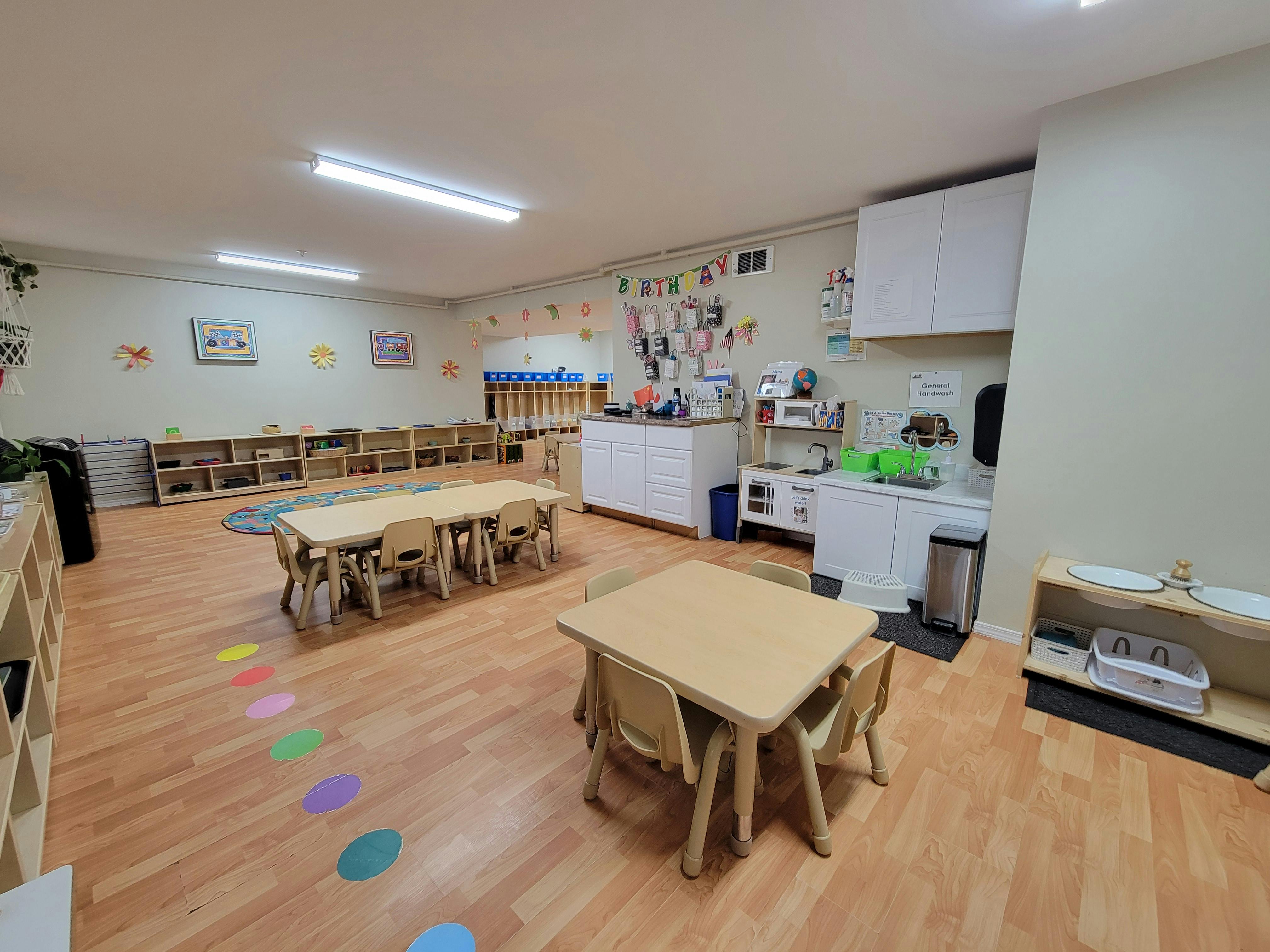 Empty classroom with small tables and chairs