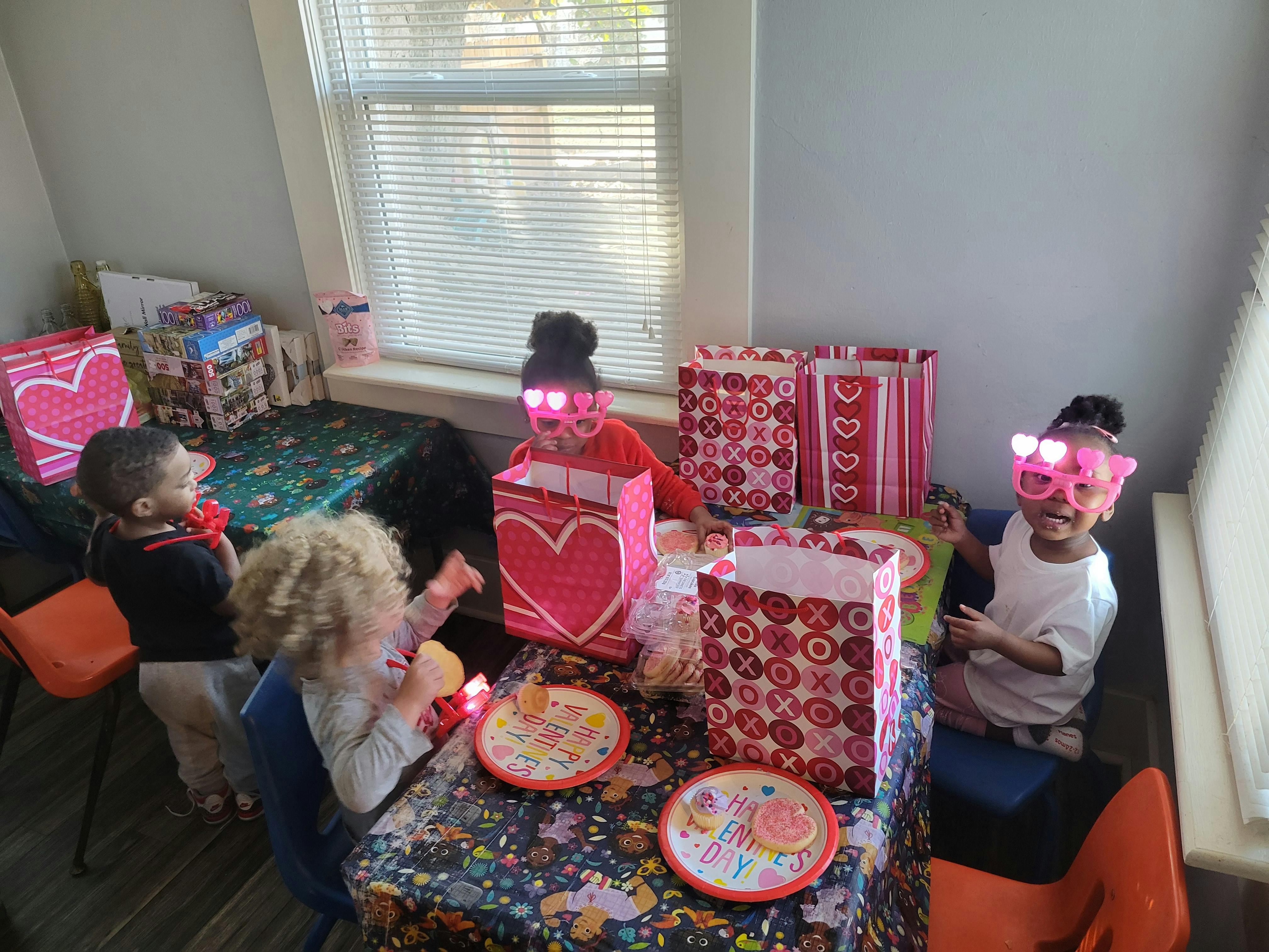 Children at a table with gift bags and plates