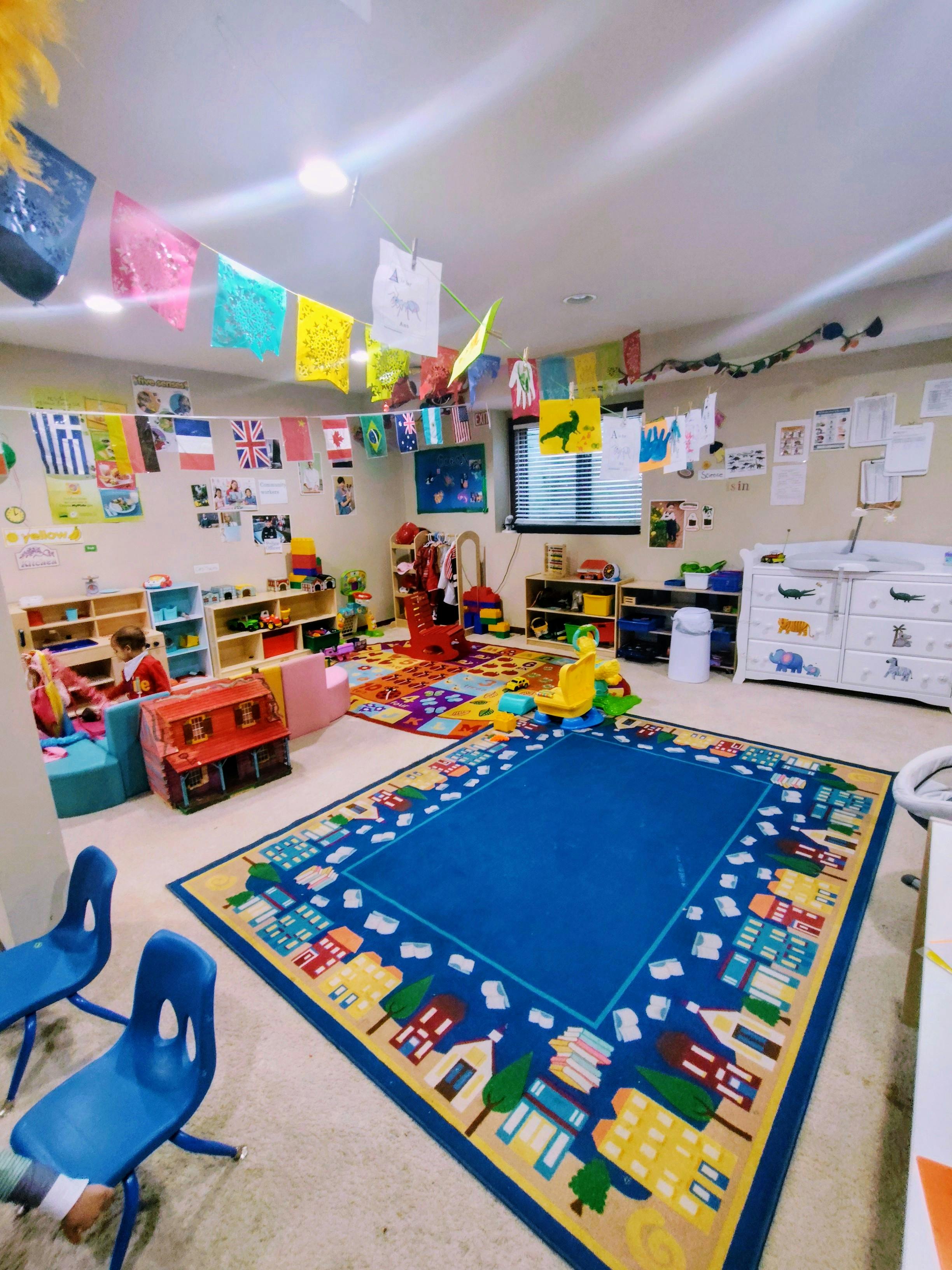 Child playing in a colorful classroom with toys and learning materials