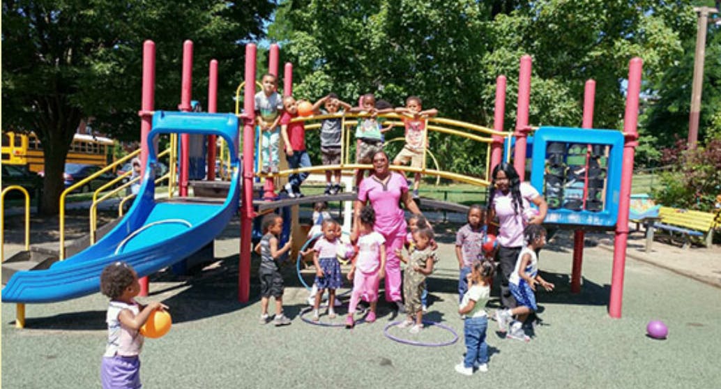 Adults and children on a playground structure