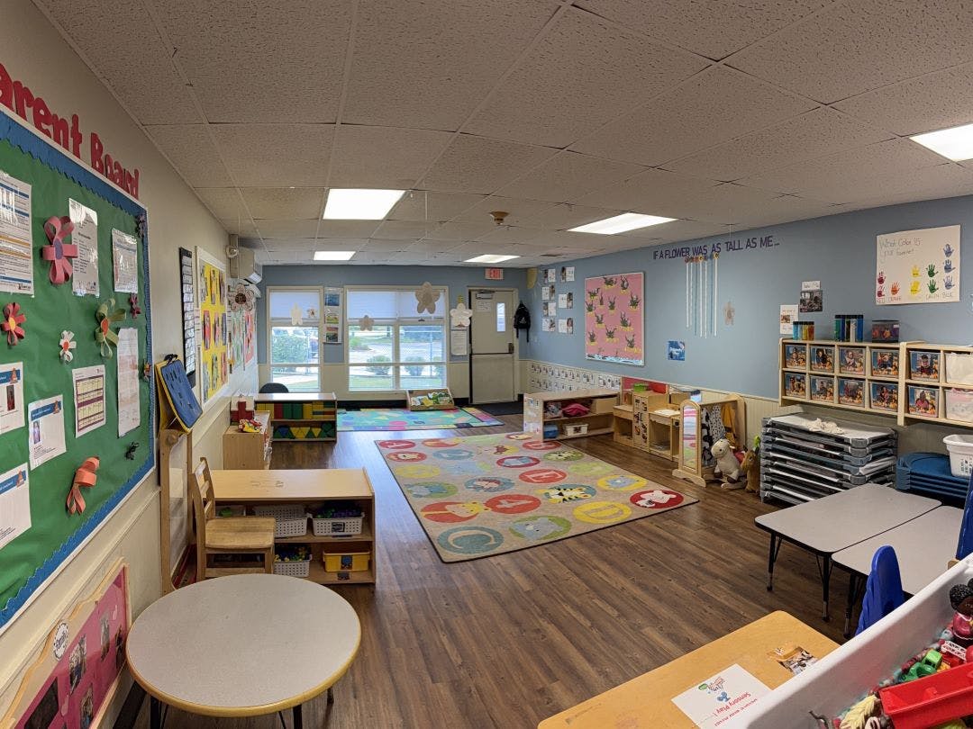 Empty classroom with children's furniture, rugs, and decorations