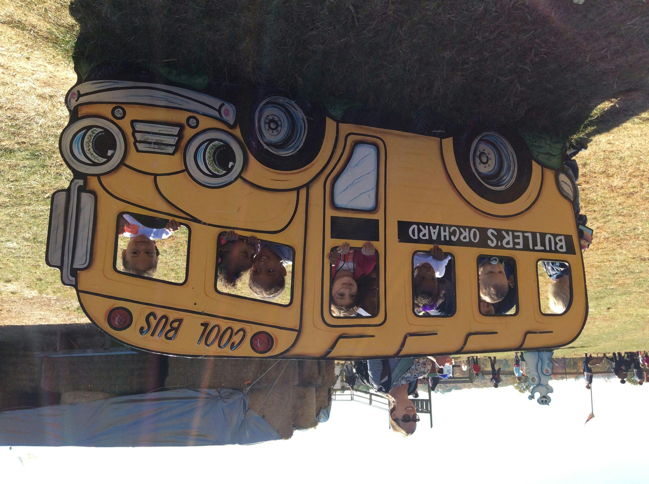 Children looking out of a school bus cutout