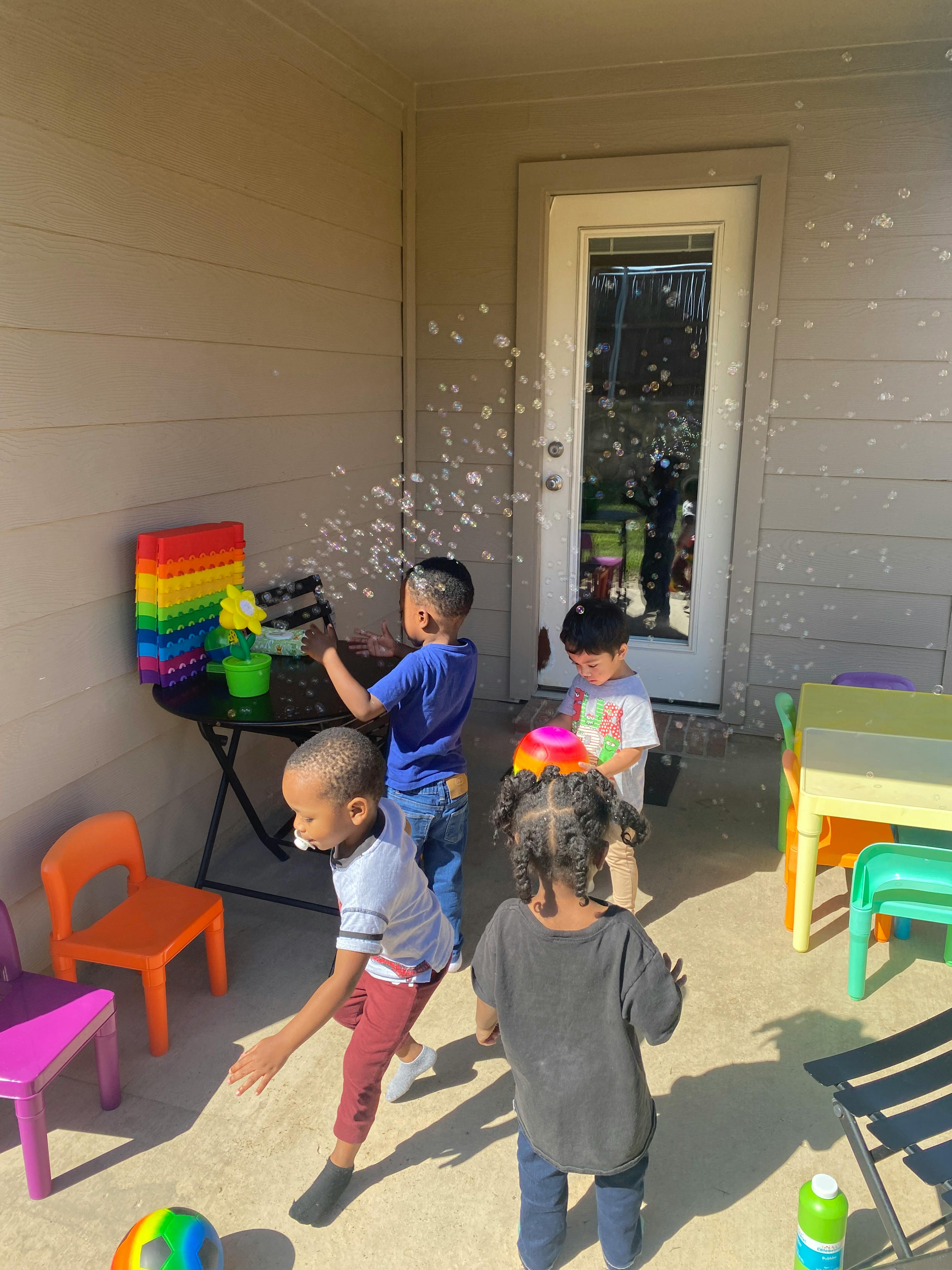 Children playing with bubbles outdoors