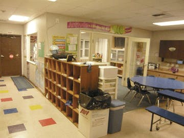 Classroom with cubbies, tables, and chairs