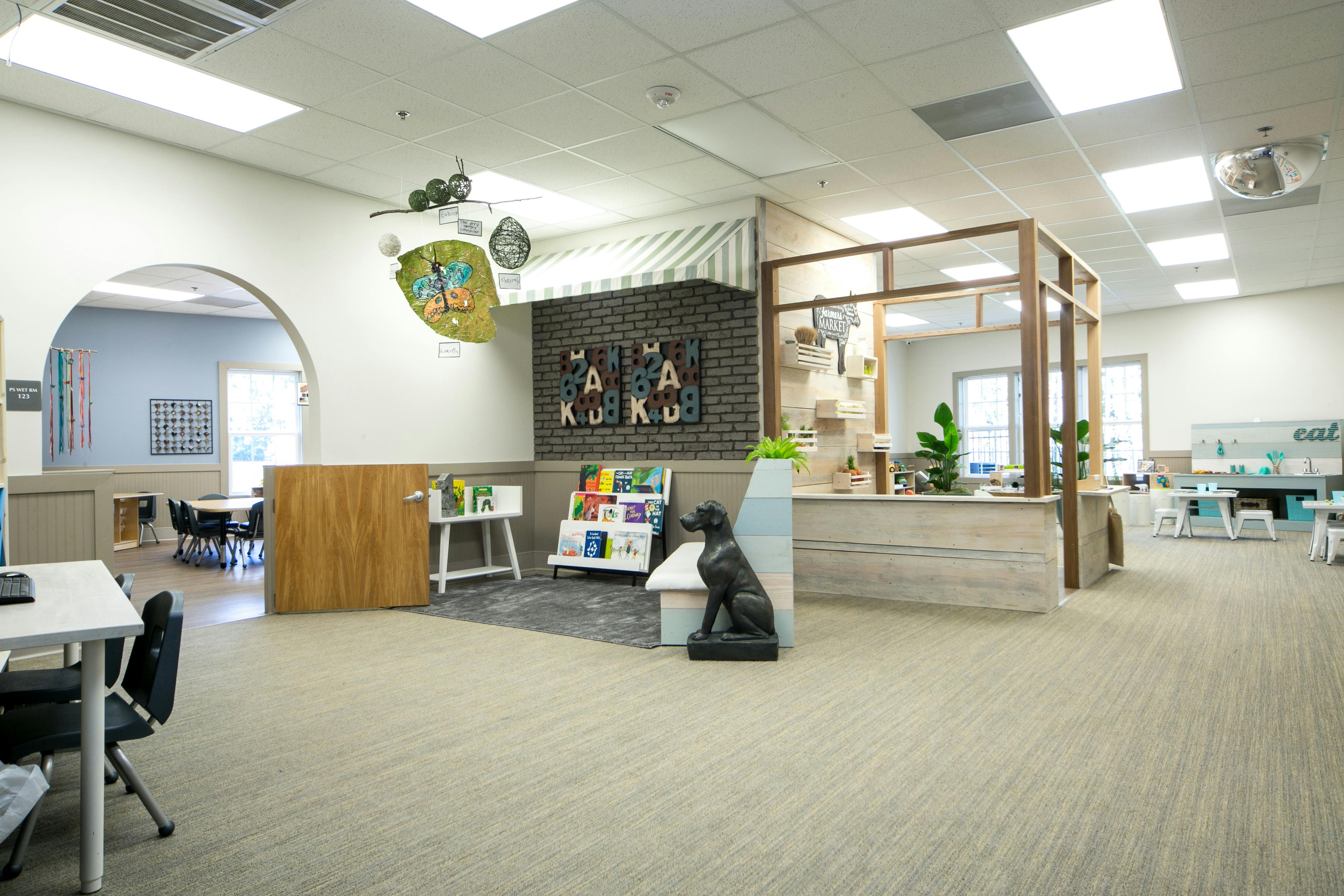 Children's play area with a small storefront and reading nook