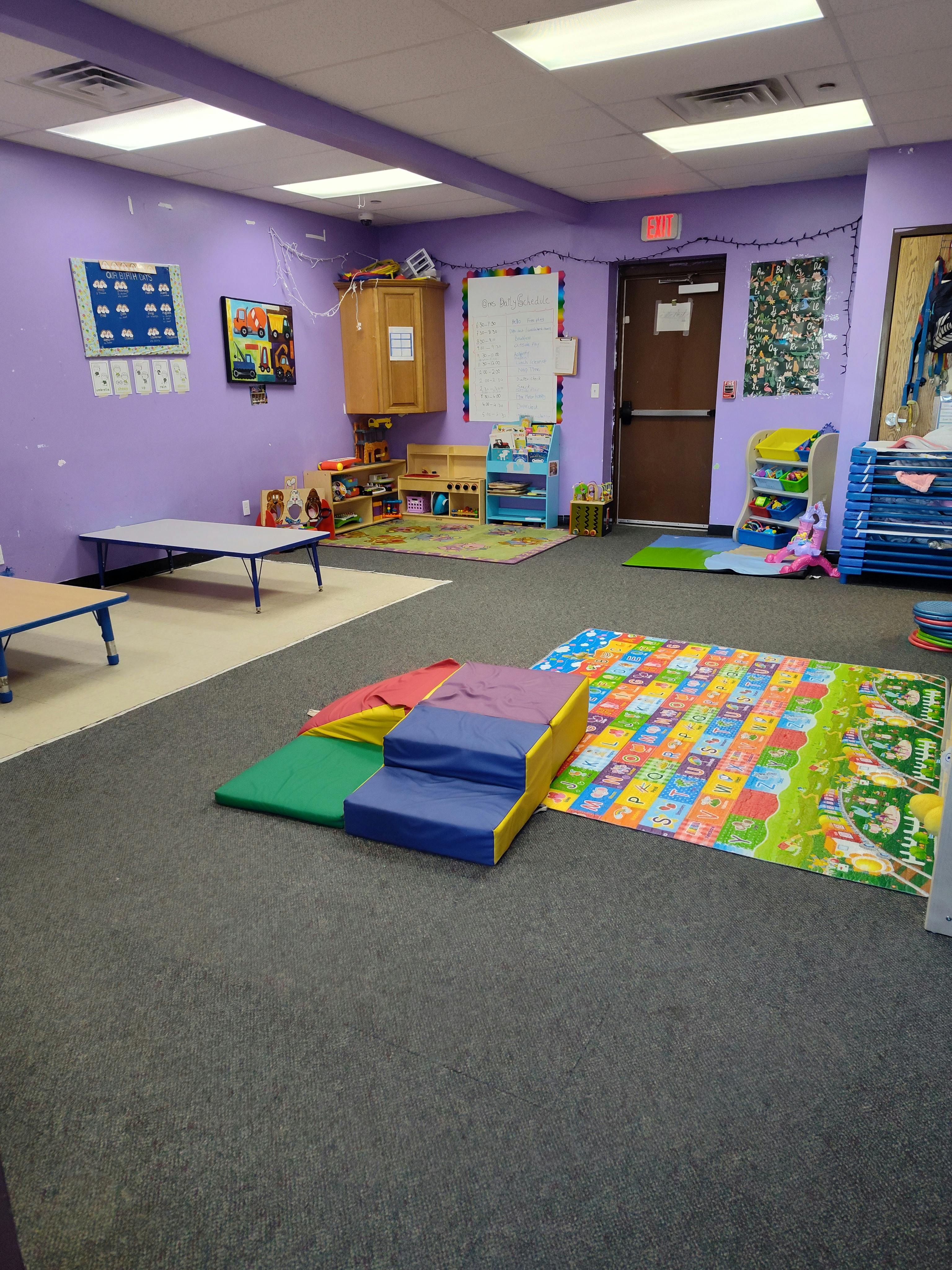 Playroom with soft play equipment and colorful mats