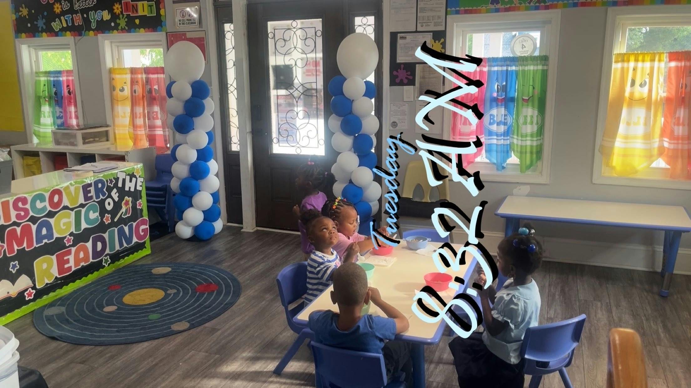 Group of children eating at a table in a classroom